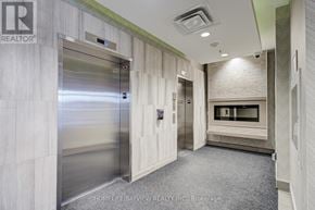 Toronto (Danforth Village-East York) condo for rent - A hallway with a stainless steel elevator and a carpeted floor.