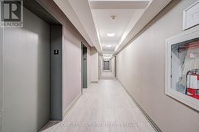 Toronto (Danforth Village-East York) condo for rent - A long hallway with doors on either side and a painting on the wall.