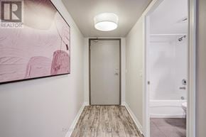 Toronto (Danforth Village-East York) condo for rent - A hallway with a door and a painting on the wall.
