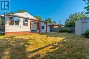 Hamilton (Westcliffe) apartment for rent - A house with a red door and a brown roof is surrounded by a fence and has a grassy yard.