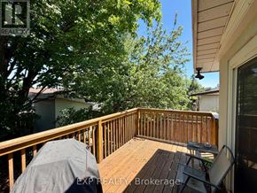 Ottawa apartment for rent - A wooden deck with a table and chairs is covered with a grey tarp.