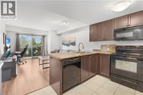 Guelph condo for rent - A modern kitchen with dark brown cabinets and stainless steel appliances.