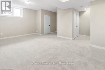 Ottawa townhouse for rent - A spacious empty room with two doors and a window.
