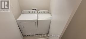 Ottawa townhouse for rent - A white dryer and washer in a small laundry room.