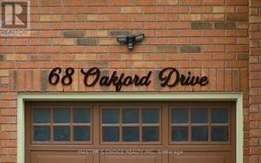 Markham (Cachet) apartment for rent - A brick building with a sign that says 68 Oakford Drive.