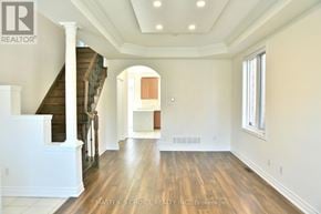 Markham (Cachet) apartment for rent - A spacious room with wood flooring and a staircase.