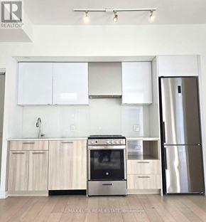 Toronto (Church-Yonge Corridor) condo for rent - A modern kitchen with white cabinets and stainless steel appliances.