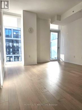 Toronto (Church-Yonge Corridor) condo for rent - A large, empty room with wooden floors and white walls.