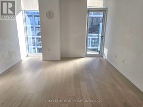 Toronto (Church-Yonge Corridor) condo for rent - A room with wooden floors and a large window.
