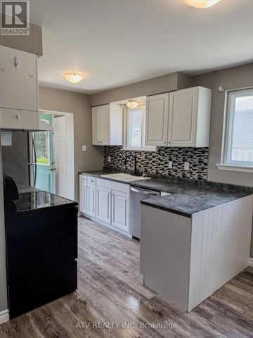 Woodstock (Woodstock - South) apartment for rent - A kitchen with a black counter top and white cabinets.