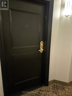 Vaughan (Crestwood-Springfarm-Yorkhill) condo for rent - A black door with a white handle and a brochure on the floor.