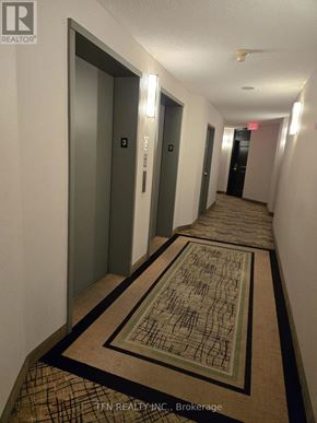 Vaughan (Crestwood-Springfarm-Yorkhill) condo for rent - A hallway with a rug on the floor and two doors on the left.