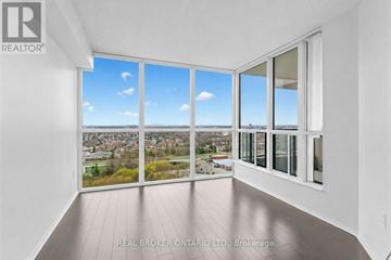Toronto (Mount Olive-Silverstone-Jamestown) condo for rent - A real estate office is showcasing a property with a large window overlooking a city.