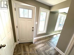 St. Catharines (Burleigh Hill) apartment for rent - A white door with a window above it in a room with a wooden floor.