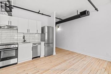 London East (East K) multi-family for rent - A kitchen with white cabinets and stainless steel appliances.