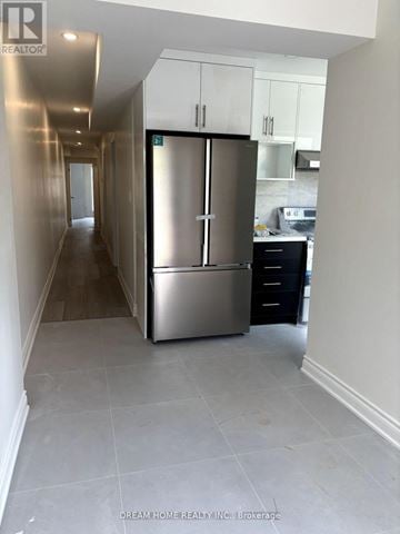 Toronto (Kensington-Chinatown) apartment for rent - A kitchen area with a refrigerator and a stove.