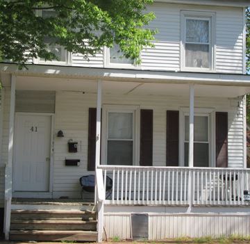 Dover apartment for rent - A white house with a porch and a mailbox on the front door.