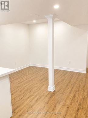 Toronto (Malvern) apartment for rent - A room with a white column and wooden flooring.