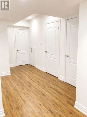 Toronto (Malvern) apartment for rent - A room with white doors and wooden floors.