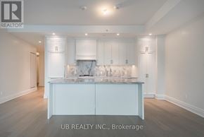 Ottawa condo for rent - A white kitchen with a marble island and cabinets.