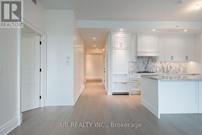 Ottawa condo for rent - A spacious kitchen with white cabinets and a marble countertop.