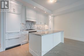 Ottawa condo for rent - A kitchen with white cabinets and a marble backsplash.