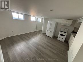 Toronto (East End-Danforth) apartment for rent - A spacious room with wood flooring and white walls.