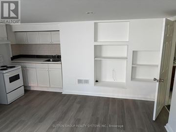 Toronto (East End-Danforth) apartment for rent - A kitchen with white cabinets and a stove top oven.