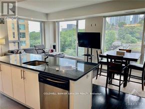 Ottawa condo for rent - A modern kitchen with a large island and a view of the city.