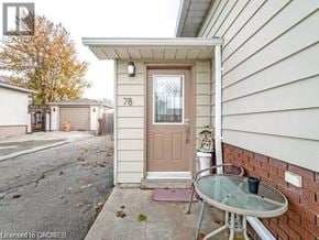 Hamilton apartment for rent - A small house with a brown door and a glass table with a cup on it.