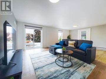Kawartha Lakes (Bobcaygeon) apartment for rent - A living room with a black couch and a coffee table.
