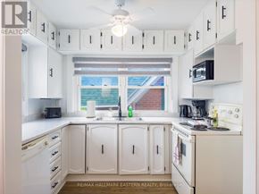 Kawartha Lakes (Bobcaygeon) apartment for rent - A white kitchen with a window and a sink.