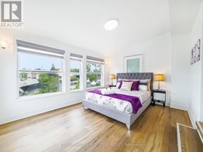 Kawartha Lakes (Bobcaygeon) apartment for rent - A bedroom with a large bed and a view of the outside through the windows.