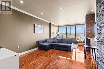 London North (North C) condo for rent - A living room with a couch and a large window.