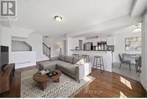 Ottawa townhouse for rent - A living room with a grey sofa and a wooden coffee table.
