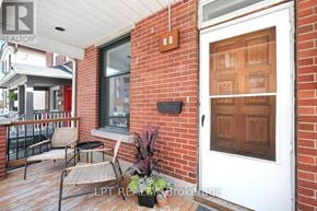 Ottawa duplex for rent - A white door with a glass window is on a brick wall.