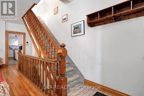 Ottawa duplex for rent - A wooden staircase with a white wall and a framed picture on the wall.