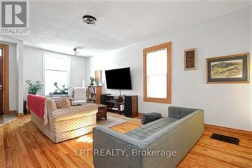 Ottawa duplex for rent - A living room with a grey couch and a television.