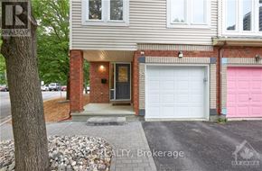 Ottawa townhouse for rent - A house with a pink garage door is for sale.