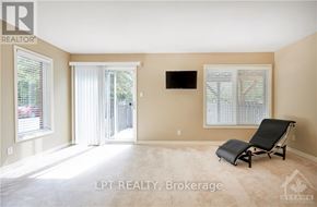 Ottawa townhouse for rent - A living room with a chair and a flat screen TV.