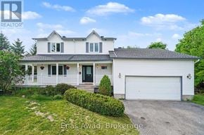Ottawa apartment for rent - A white house with a black door and a garage door.