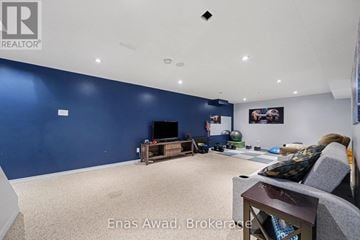 Ottawa apartment for rent - A living room with a grey couch and a television.