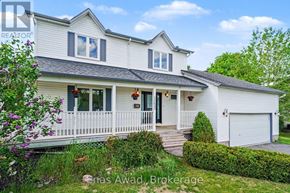 Ottawa apartment for rent - A white house with a grey roof and a white fence.