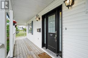 Ottawa apartment for rent - A black door with a glass window is on a white house.