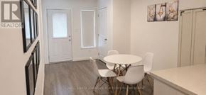 Welland (Broadway) townhouse for rent - A dining room with a white table and chairs.