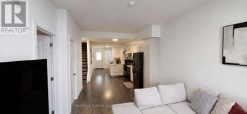 Welland (Broadway) townhouse for rent - A living room with a white couch and a television.