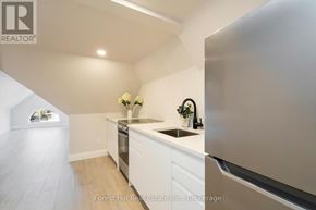 Collingwood condo for rent - A kitchen with a refrigerator, sink, and stove.