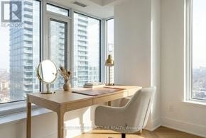 Toronto (Annex) condo for rent - A well-lit room with a desk and chair in front of a large window.