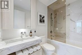 Toronto (Annex) condo for rent - A white bathroom with a marble counter top and a toilet.