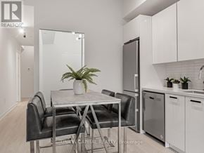 Toronto (Kensington-Chinatown) condo for rent - A modern kitchen with a dining table and chairs.